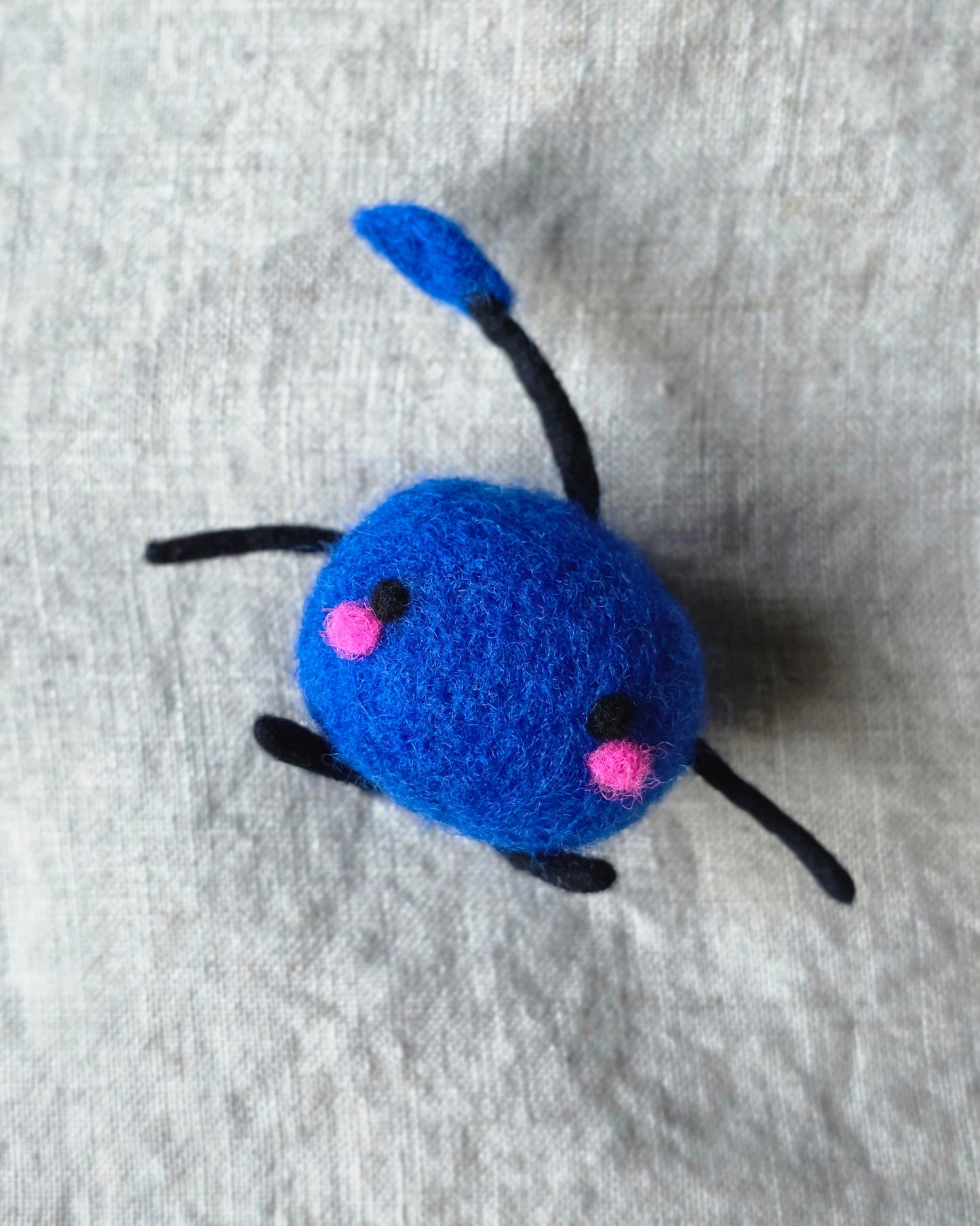 An adorable felted Junimo.